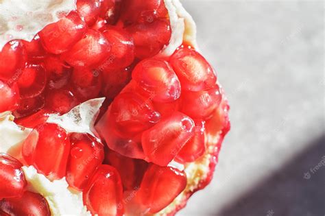 Premium Photo | Pomegranate seeds closeup pomegranate on a light background