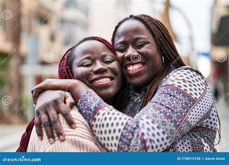 African American Women Friends Smiling Confident Hugging Each Other At