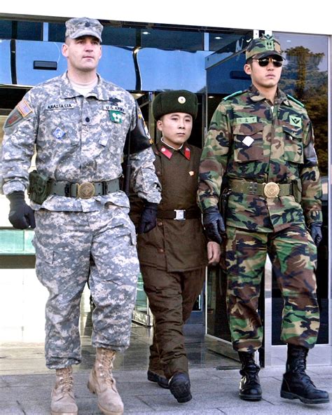 Repatriated North Korean Soldier Walking In Between An American 1st Infantry Division And A