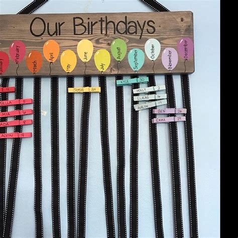 A Wooden Sign That Says Our Birthdays Are Made Out Of Clothes Pins And