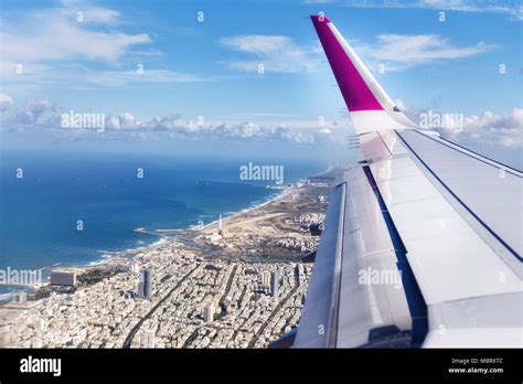 Top view from landing airplane. Window plane with copy space. Aerial view of cloud, sea, ocean ...