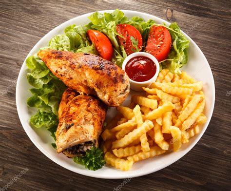 Roasted chicken breast, French fries and vegetables Stock Photo by ...