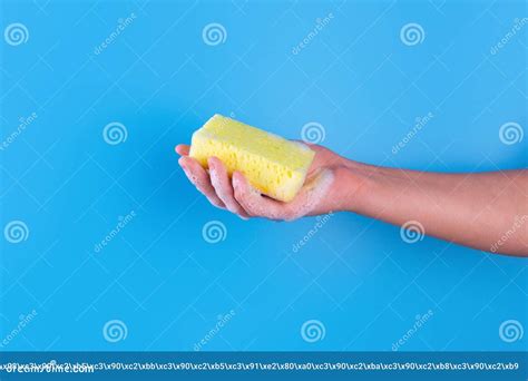 Persons Hand Holding Yellow Sponge For Dish Wash Washcloth Covered In