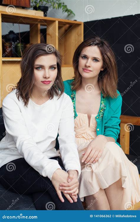 Happy Young Women Sitting Indoor Lifestyle Portrait Stock Photo