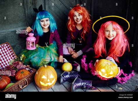 Girls In Wigs And Traditional Halloween Costumes Stock Photo Alamy