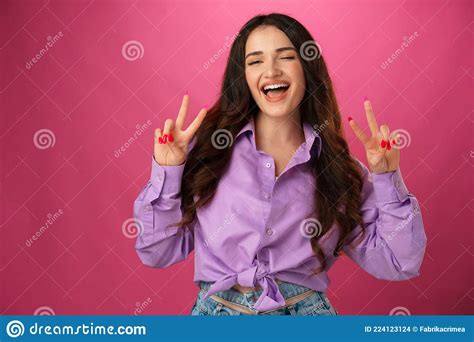 Happy Smiling Woman Showing Victory Sign Against Pink Background Stock