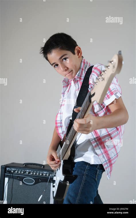 Teen Boy Playing Electric Guitar Isolated Over Withe Gray Background