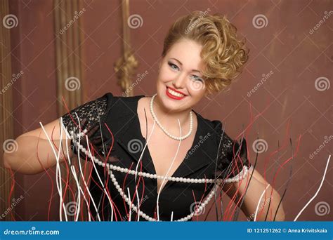 Stylish Blonde In A Black Dress With A Pearl Necklace Stock Photo Image Of Glamor Hand