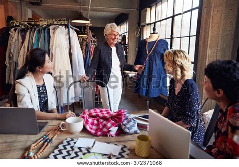 Four Fashion Designers Meeting Discussing Garment Stock Photo Edit Now