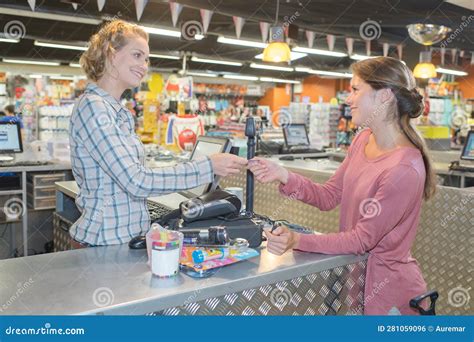 Customer Paying For Shopping At Supermarket Checkout Stock Photo