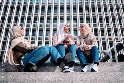 Three Muslim Women Talking And Laughing Stock Photo Adobe Stock