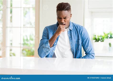 Handsome African American Man At Home Feeling Unwell And Coughing As