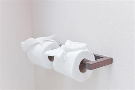 Premium Photo Close Up Of Toilet Papers Hanging On Wall