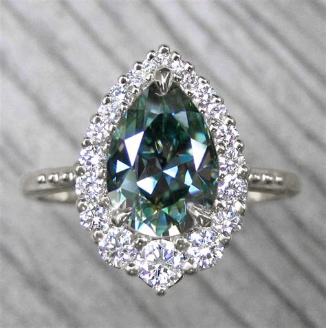 ・celeste・aqua Teal Iconic™ Pear Moissanite Center Diamond Halo 1