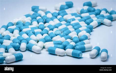 Blue And White Capsule Pills On White Background Antibiotics Drug