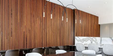 A Conference Room With Wooden Walls And White Chairs In Front Of A