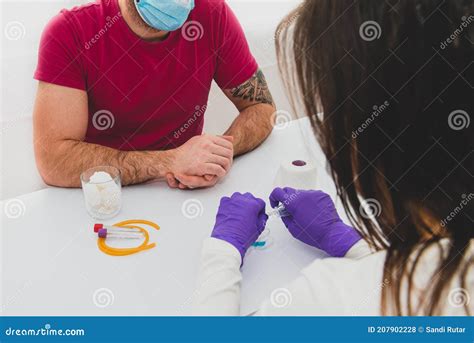 Nurse With Butterfly Needle Taking Blood For Antibody Test Of Male