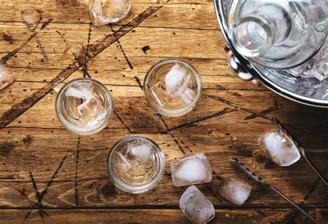 Russian Vodka In Shot Glasses On Wooden Table Iced Strong Alcohol Drink In Misted Glass Top