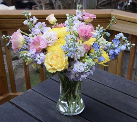 Flower Arrangement With Yellows Pinks And Blues In Blue Flower