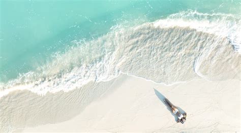 Above View Of Woman In White Bikini Sunbathing As Laying On The Beach Blue Sea Water In