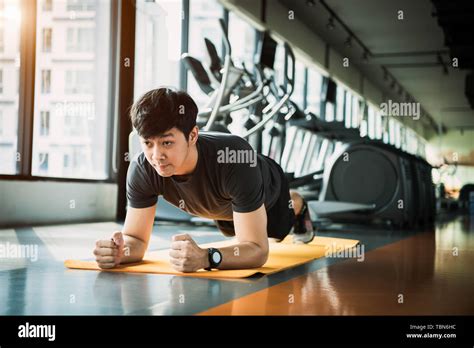 Portrait Of Asian Fitness Man Doing Planking Exercise In Gym People