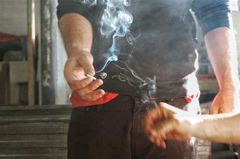 Premium Photo Cropped Image Of People Holding Burning Cigarette