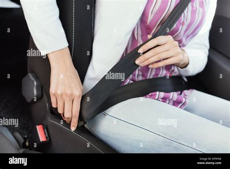 Woman Fastening The Seatbelt In Her Car Safety And Safe Driving