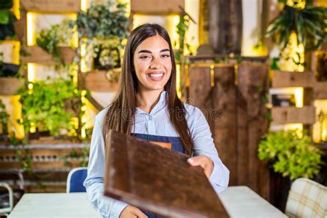 Happy Beautiful Smiling Waitress Wearing Apron Giving A Folder Menu In