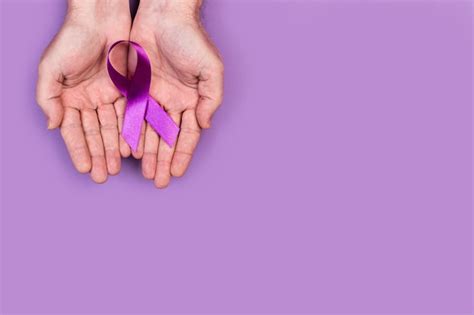 Premium Photo Man Hands Holding A Purple Ribbon On Purple