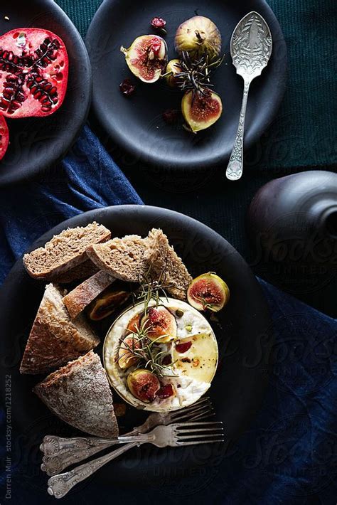 Baked Camembert Cheese And Fruits On Plates On A Table Seen From Overhead By Stocksy