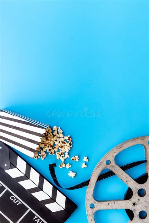 Popcorn With Clapperboard And Movie Film Reel Cinema Background Stock