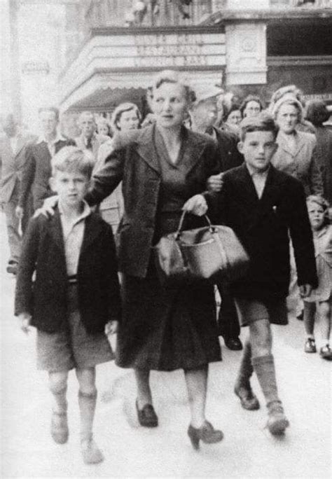 George Harrison and his older brother Peter with their mother walking ...