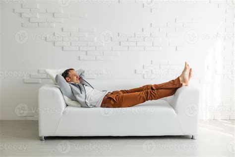 Mature Man On Couch Watching Television 16207833 Stock Photo at Vecteezy