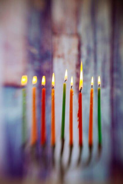 Premium Photo Multi Colored Illuminated Candles Against Wall