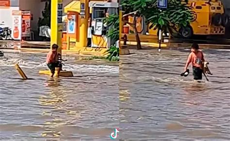 Ni O Carga A Perro Para Ayudarlo A Cruzar Una Calle Inundada Chapin Tv