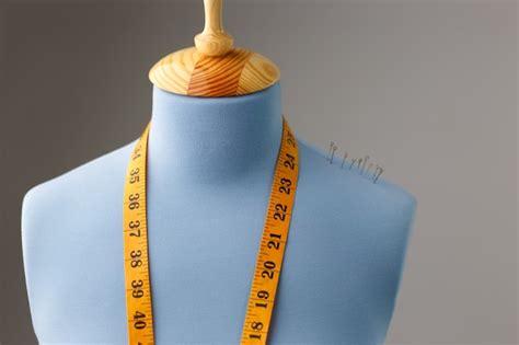 Premium Photo Blue Tailor Dummy With Measuring Tape Alongside The Wall