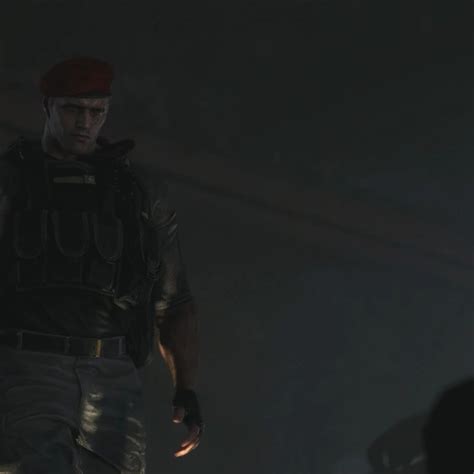 A Man With A Red Beret Is Standing In The Dark And Looking At Something