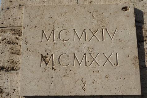 Roman Numerals Mcmxiv And Mcmxxi Engraved In White Stone Translation