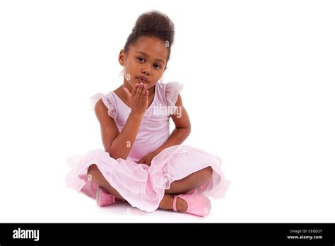 Cute little African Asian girl sitting on the floor, isolated on white background Stock Photo ...