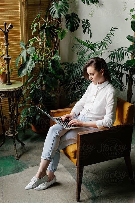 "Woman Working On Laptop In Modern Workspace" by Stocksy Contributor ...