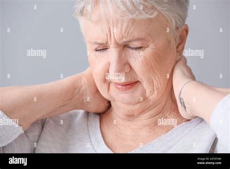 Senior Woman Suffering From Neck Pain At Home Stock Photo Alamy