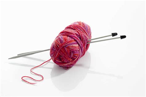 Yarn With Knitting Needles On White Background Close Up Stock Photo