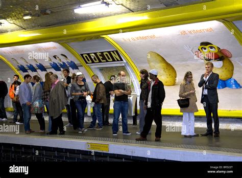 People Wait Underground On The Platform Of The Odeon Paris Metro