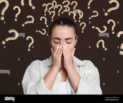 Amnesia Confused Young Woman And Question Marks On Brown Background