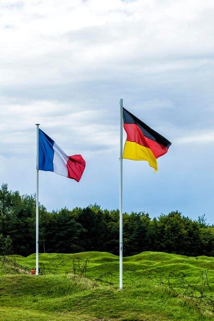 Premium Photo Flag Flags On Field Against Sky