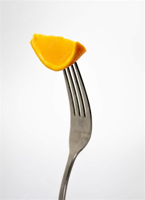 Premium Photo A Fork With A Piece Of Mango On It