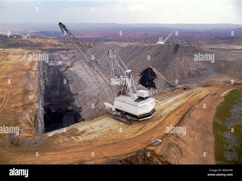 Aerial View Of Open Pit Coal Mine And Dragline Digging Machine Stock