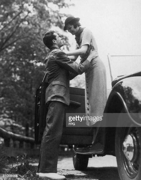 A Man Helps A Woman Out Of A Car Circa 1935 News Photo Getty Images