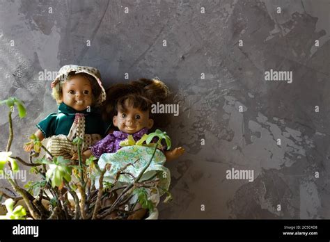 Old Scary Ugly Dolls In Front Of Concrete Wall Stock Photo Alamy