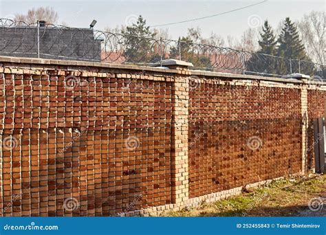 Red Brick Wall And Barbed Wire On Top Of It Stock Image Image Of